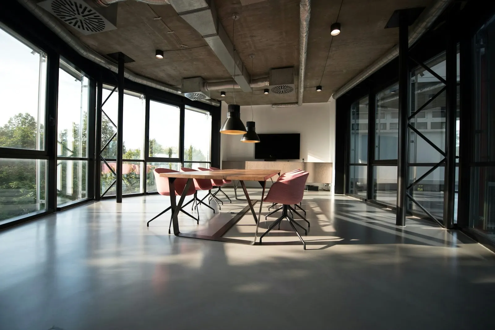 Meeting room beside large office windows