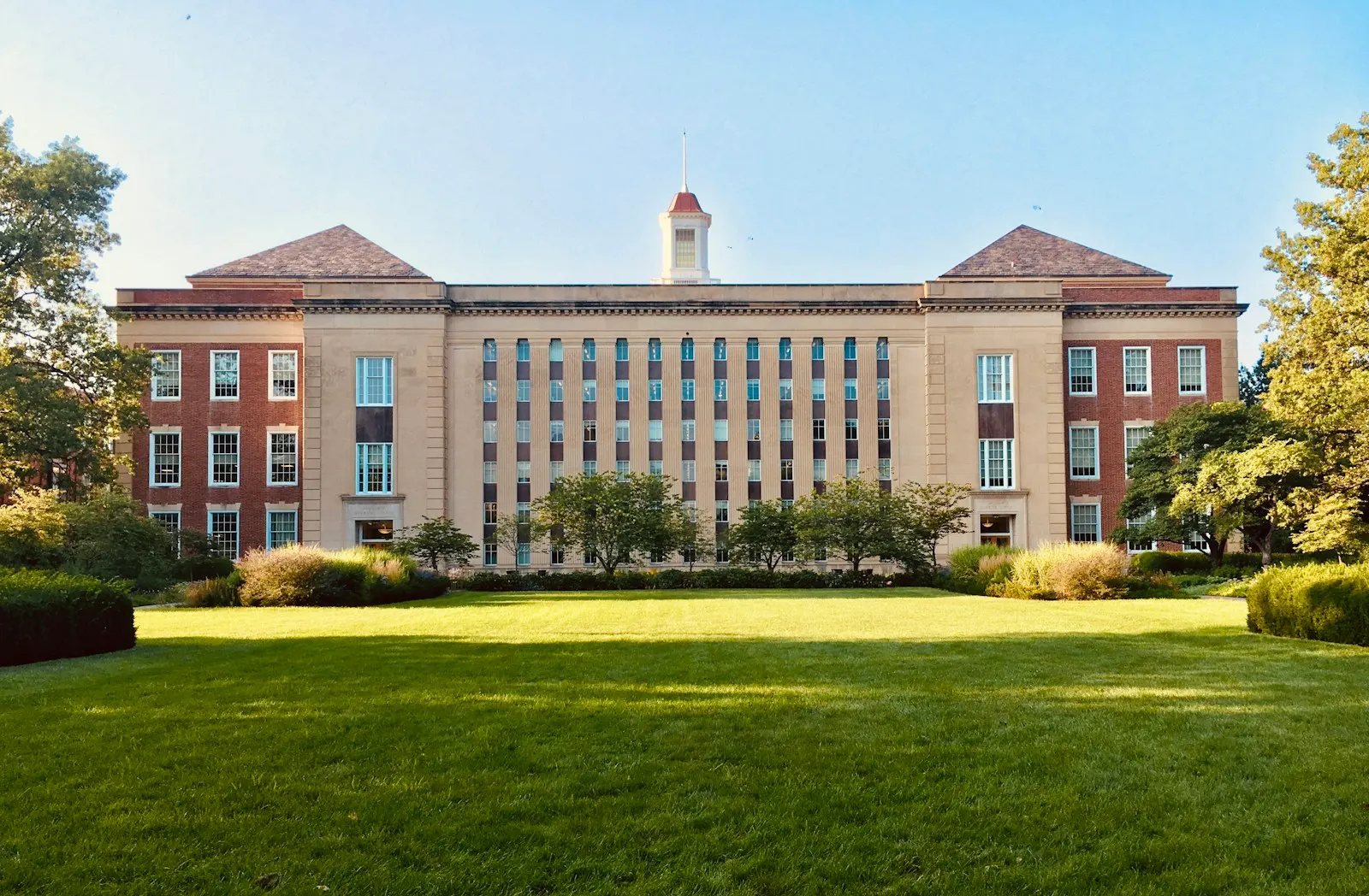 University building beyond a green lawn