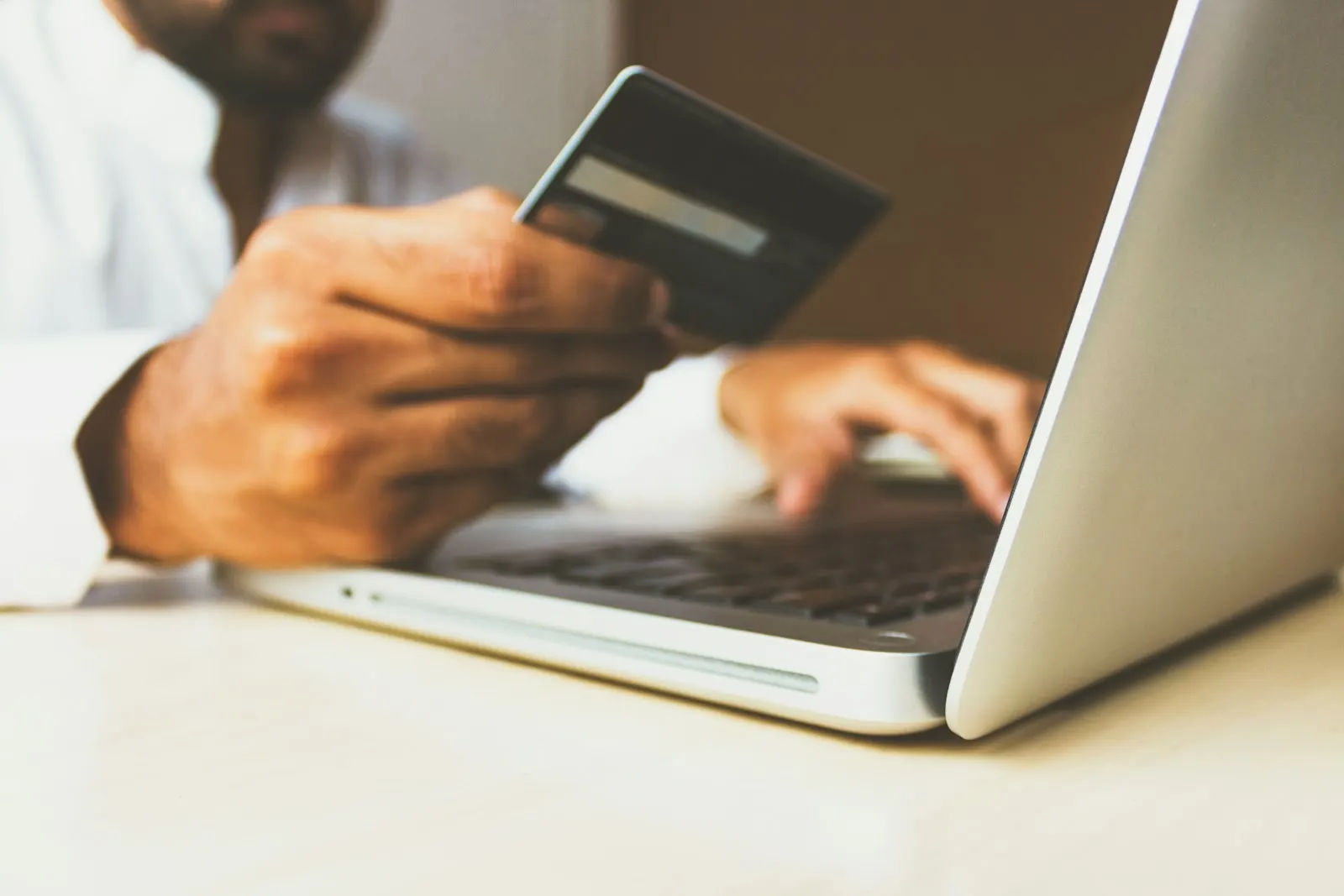 Credit card beside a laptop