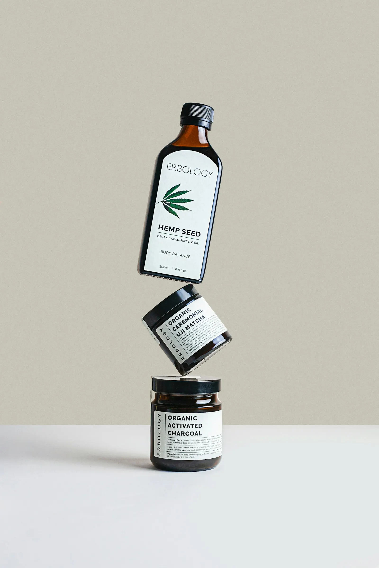 Skincare bottles stacked against a plain background